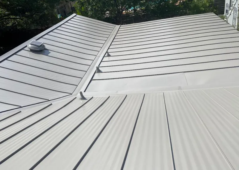 Solar attic fan installed on a metal roof for Roof Ventilation in Sandy Springs